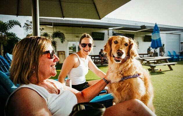 Women sitting in the garden with a dog